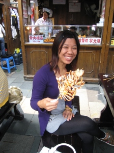 Young lady enjoying crab on a stick